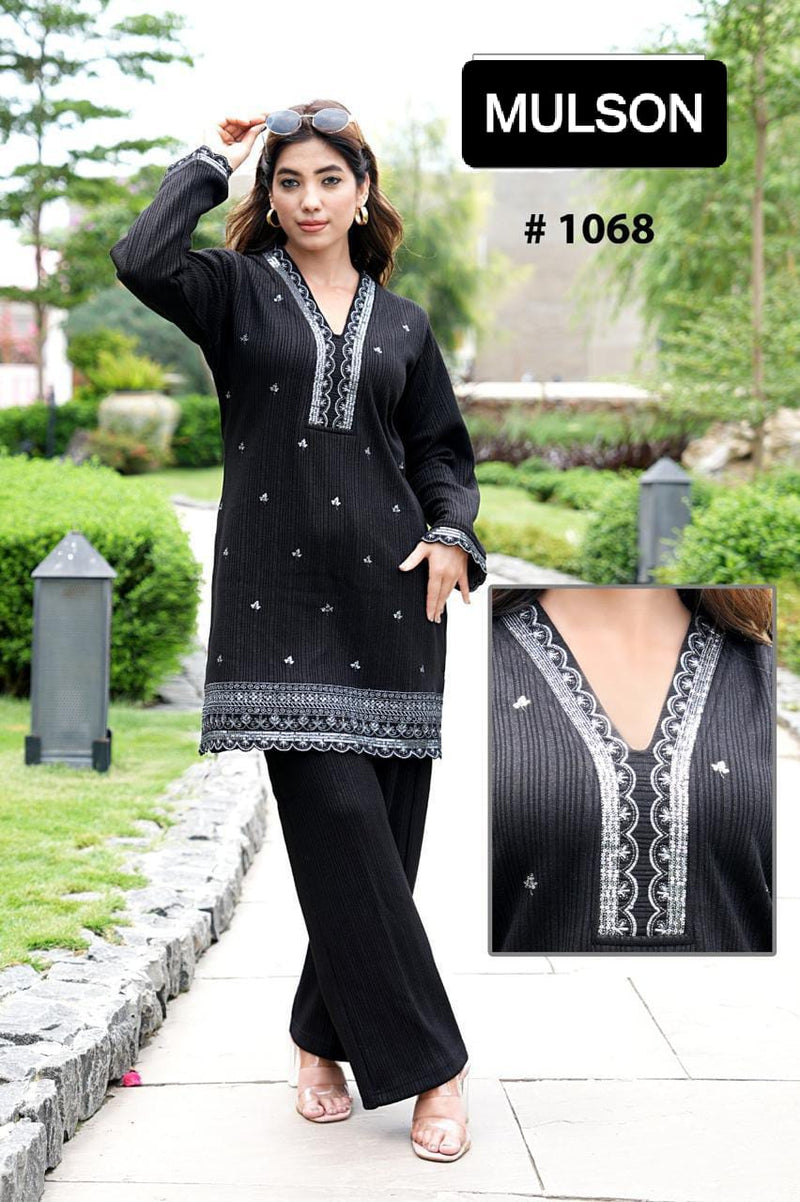 Mulson Design a timeless black co-ord set that defines sophisticated elegance. Tailored to perfection, this ensemble features a beautifully embroidered kurta with fine thread detailing on the neckline and hem, paired with straight-fit