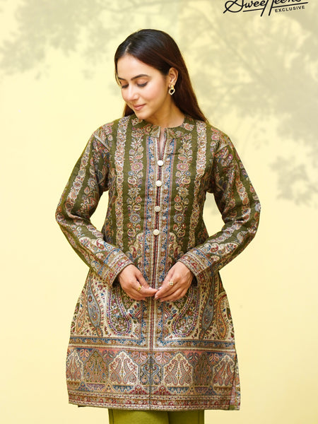 A beautifully crafted ethnic kurti featuring rich Kashmiri-inspired tapestry design in warm earthy hues. Designed with intricate detailing and a timeless silhouette, this piece brings effortless elegance to every occasion. Perfect for festive gatherings,